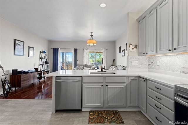 5611 S Sicily Cir, Aurora, CO 80015 - kitchen with tasteful backsplash, stainless steel dishwasher, gray cabinetry, a sink, and a peninsula