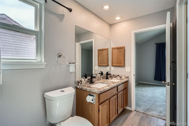 13155 W 63rd Pl, Arvada, CO 80004 - bathroom with double vanity, plenty of natural light, and wood finished floors
