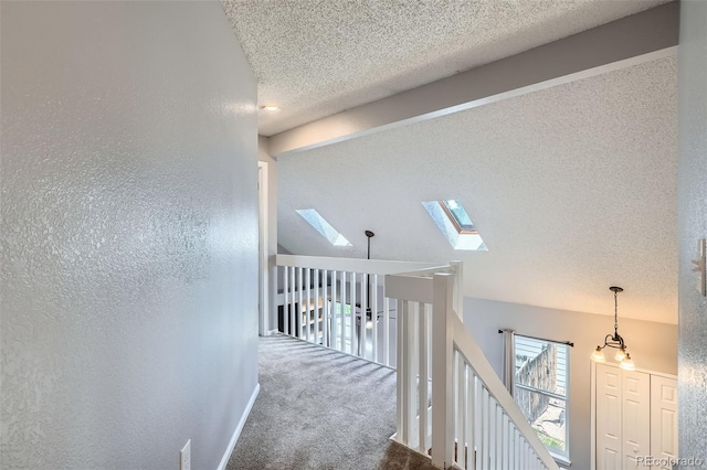 13155 W 63rd Pl, Arvada, CO 80004 - hallway featuring a skylight, a textured ceiling, and carpet