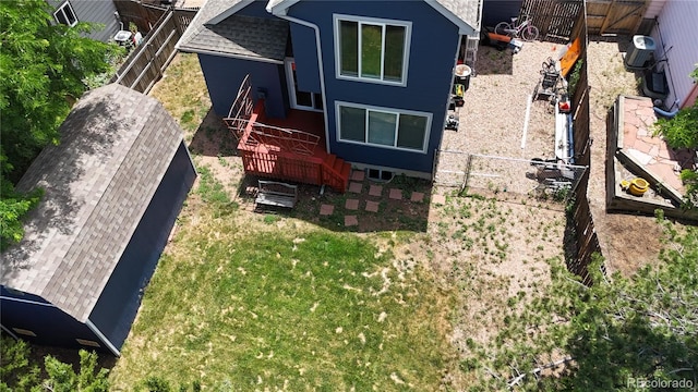 13155 W 63rd Pl, Arvada, CO 80004 - view of side of property featuring a fenced backyard, a deck, and a shingled roof