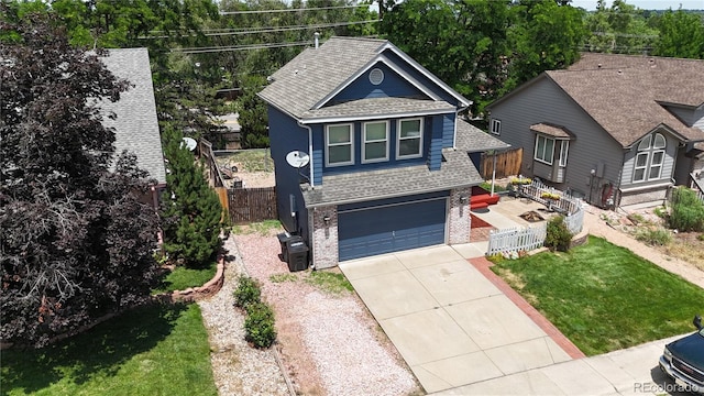 13155 W 63rd Pl, Arvada, CO 80004 - view of front of home featuring roof with shingles, driveway, brick siding, and an attached garage