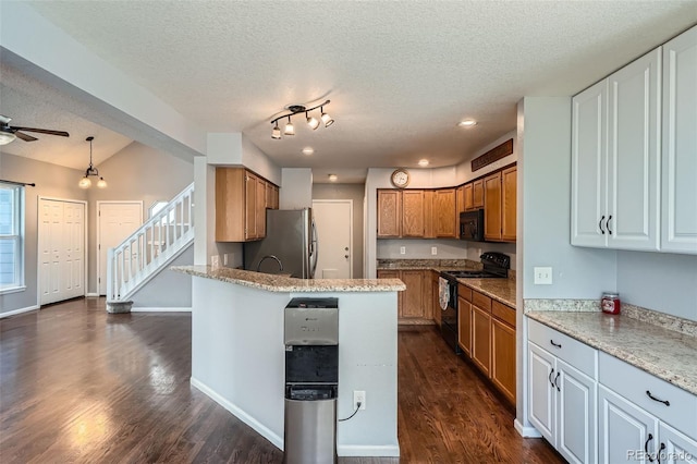 13155 W 63rd Pl, Arvada, CO 80004 - kitchen with black appliances, a textured ceiling, dark wood-type flooring, a ceiling fan, and a peninsula
