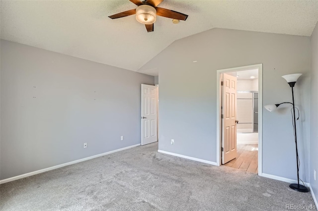 13155 W 63rd Pl, Arvada, CO 80004 - unfurnished bedroom with light colored carpet, vaulted ceiling, ensuite bath, and ceiling fan