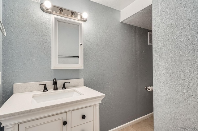 13155 W 63rd Pl, Arvada, CO 80004 - bathroom featuring vanity and a textured wall