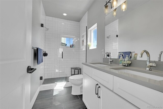 7035 E 38th Ave Unit 4, Denver, CO 80207 - full bath with toilet, a stall shower, tile patterned flooring, double vanity, and recessed lighting