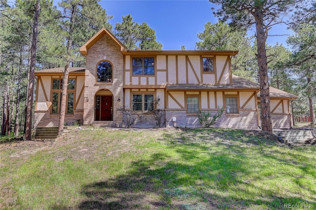 70 Long Bow Cir, Monument, CO 80132 - view of front of house with stucco siding, a front lawn, and brick siding