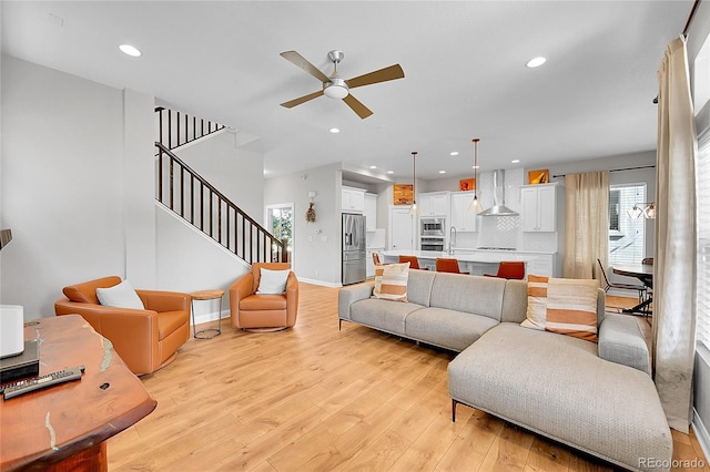 6632 Osage St, Denver, CO 80221 - living area featuring a ceiling fan, light wood-type flooring, stairs, recessed lighting, and baseboards