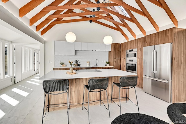 kitchen with tasteful backsplash, light countertops, appliances with stainless steel finishes, modern cabinets, and a sink