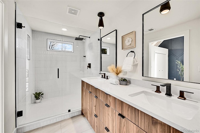 full bath featuring a sink, visible vents, and a shower stall