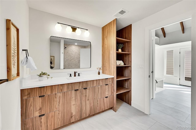 bathroom featuring visible vents, vanity, and a shower