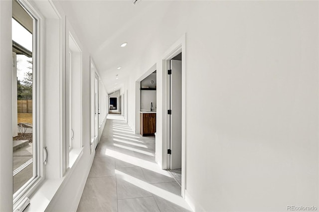 hall with light tile patterned floors and recessed lighting