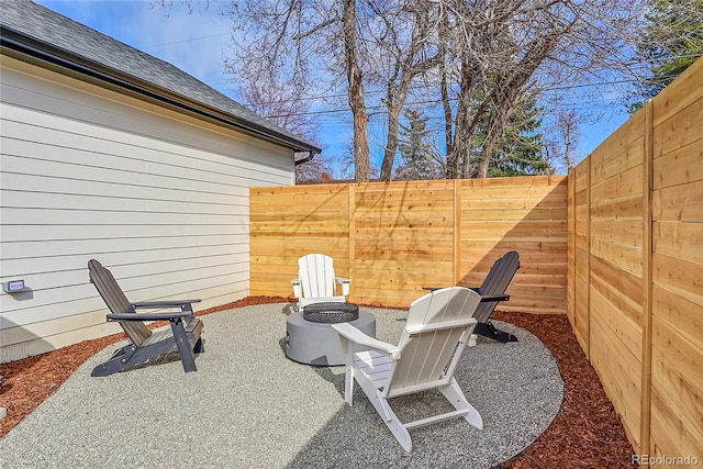 view of patio featuring a fenced backyard and a fire pit