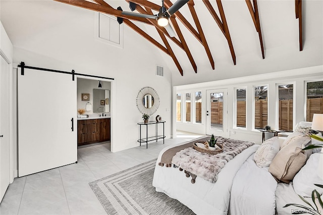 bedroom featuring light tile patterned floors, visible vents, ensuite bath, beam ceiling, and a barn door