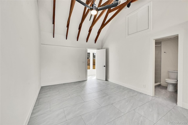 interior space featuring light tile patterned floors, beamed ceiling, high vaulted ceiling, and baseboards