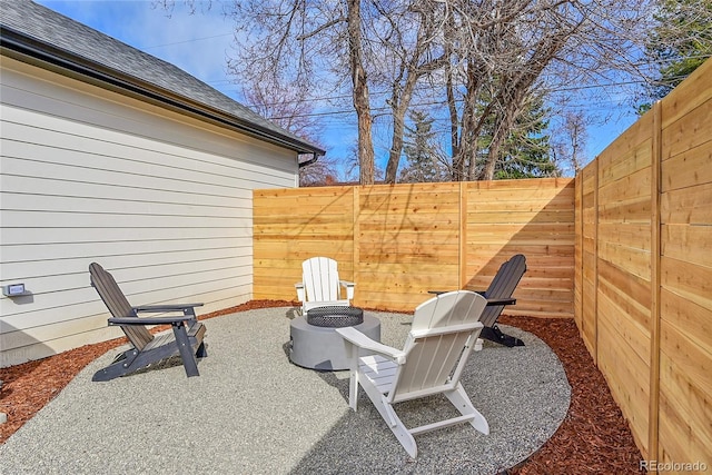 view of patio / terrace with a fenced backyard and an outdoor fire pit