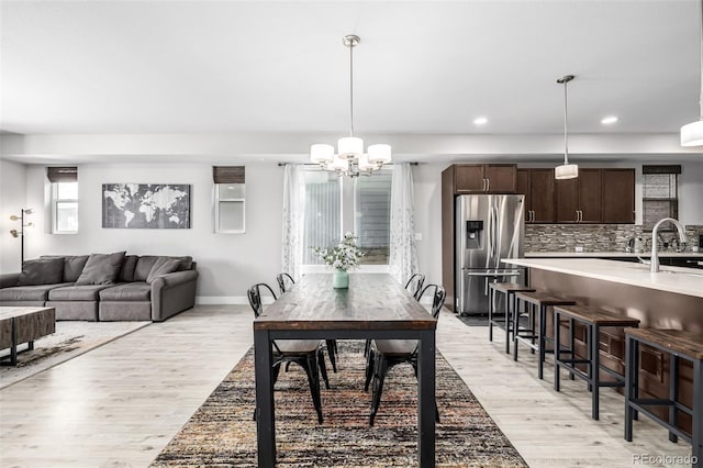 6018 Beeler Ct, Denver, CO 80238 - dining room featuring light wood-type flooring, a chandelier, recessed lighting, and baseboards