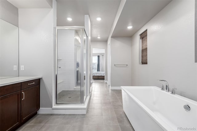 6018 Beeler Ct, Denver, CO 80238 - ensuite bathroom with a stall shower, recessed lighting, tile patterned floors, a freestanding bath, and vanity