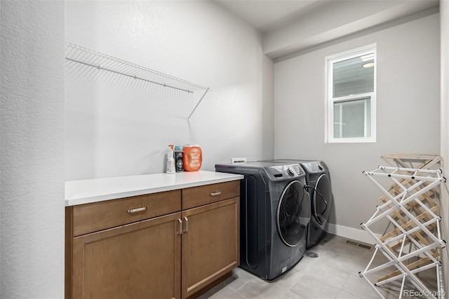 6018 Beeler Ct, Denver, CO 80238 - washroom featuring separate washer and dryer, light tile patterned flooring, and cabinet space