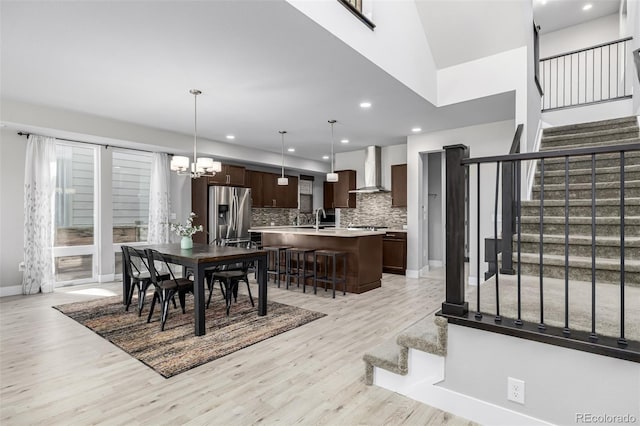 6018 Beeler Ct, Denver, CO 80238 - dining room featuring stairs, light wood-type flooring, a chandelier, recessed lighting, and baseboards