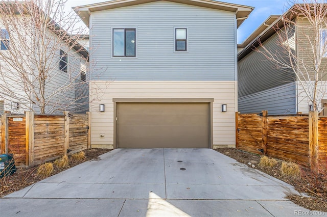 6018 Beeler Ct, Denver, CO 80238 - view of front facade featuring an attached garage, driveway, and fence