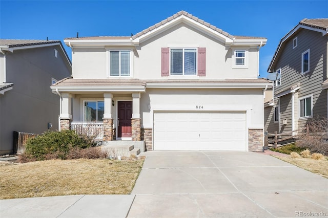 view of front of property with stone siding, concrete driveway, a tiled roof, and stucco siding