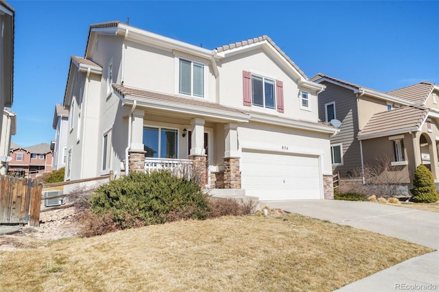 view of front facade featuring stucco siding, a porch, a garage, stone siding, and driveway