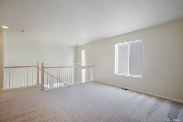 unfurnished room with carpet and visible vents