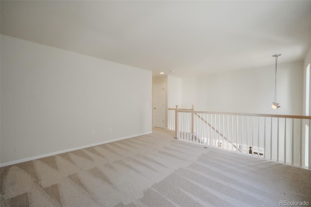 spare room featuring baseboards, recessed lighting, and light colored carpet