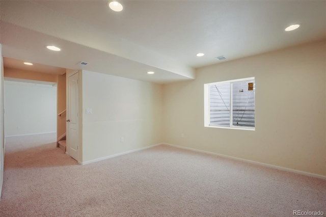 unfurnished room with recessed lighting, carpet floors, visible vents, baseboards, and stairs