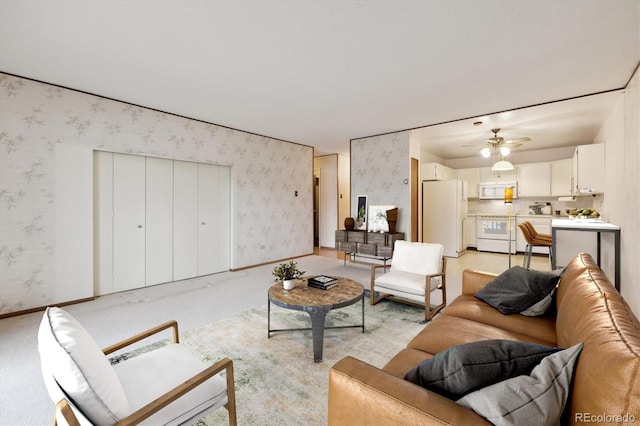 living room with light colored carpet and ceiling fan