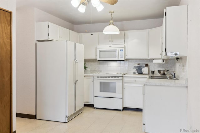 kitchen featuring white cabinetry, sink, white appliances, and pendant lighting