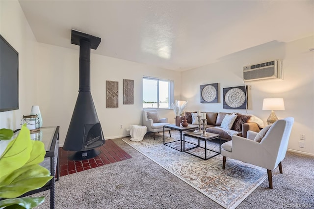 living room with carpet floors, a wood stove, a wall unit AC, and baseboards