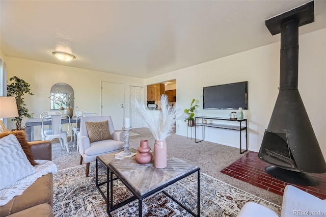 living area featuring a wood stove and baseboards