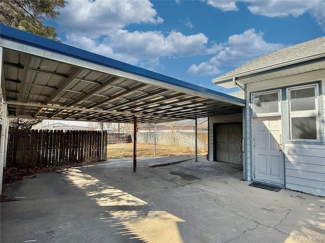 view of patio / terrace featuring a carport and fence