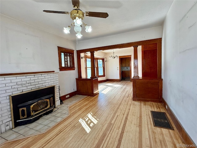 unfurnished living room with visible vents, baseboards, light wood-style floors, and ceiling fan