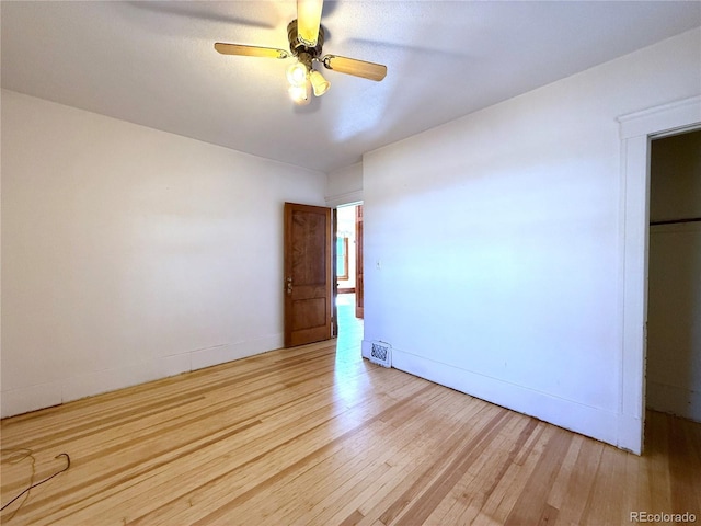 interior space featuring light wood-type flooring, baseboards, and ceiling fan