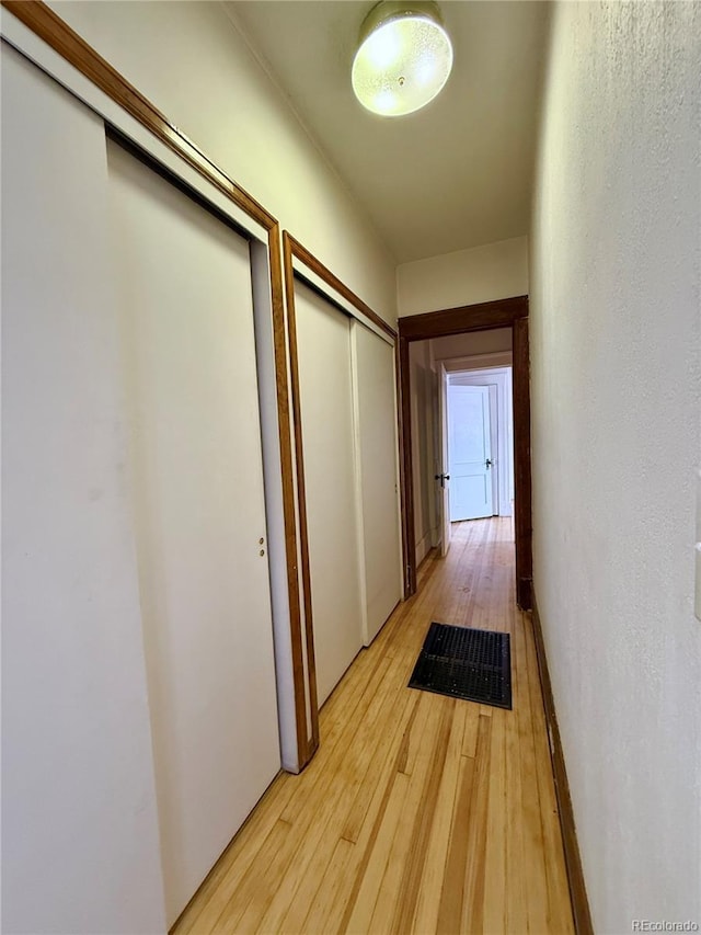 corridor with light wood-style flooring