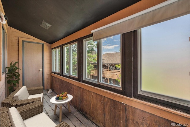 4681 S Decatur St Unit 327, Englewood, CO 80110 - sunroom with vaulted ceiling, wooden walls, and wood finished floors
