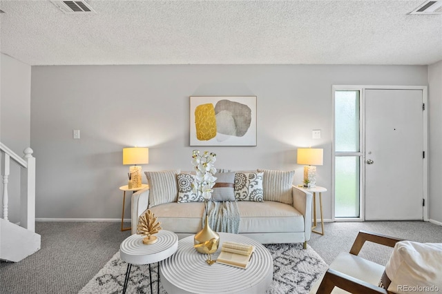 1250 S Monaco Pkwy Unit 50, Denver, CO 80224 - carpeted living area with a textured ceiling and stairs