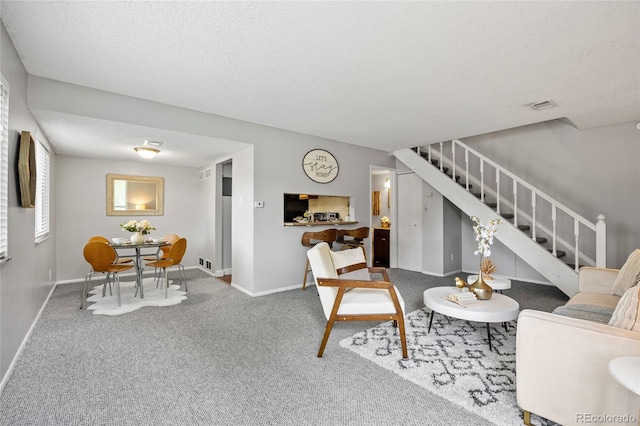 1250 S Monaco Pkwy Unit 50, Denver, CO 80224 - carpeted living room featuring stairway and a textured ceiling