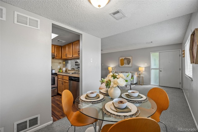 1250 S Monaco Pkwy Unit 50, Denver, CO 80224 - dining room with a textured ceiling and carpet