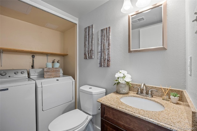 1250 S Monaco Pkwy Unit 50, Denver, CO 80224 - bathroom featuring independent washer and dryer, vanity, and a textured wall