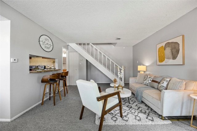 1250 S Monaco Pkwy Unit 50, Denver, CO 80224 - carpeted living area with stairway and a textured ceiling