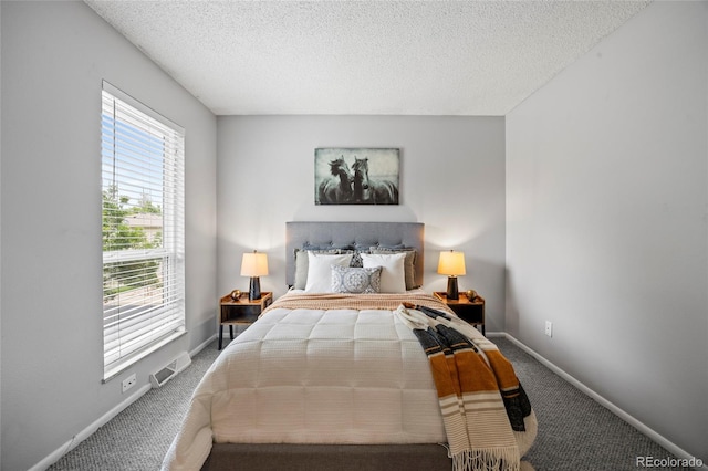 1250 S Monaco Pkwy Unit 50, Denver, CO 80224 - carpeted bedroom featuring baseboards and a textured ceiling
