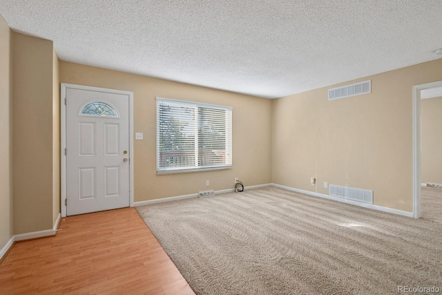 1195 S Oneida St Unit E, Denver, CO 80224 - foyer entrance with a textured ceiling and wood finished floors