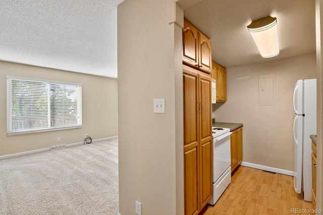 1195 S Oneida St Unit E, Denver, CO 80224 - kitchen featuring white appliances, electric panel, open floor plan, and brown cabinets