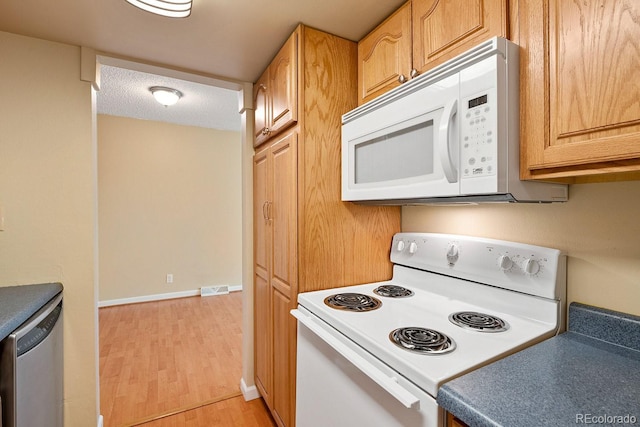 1195 S Oneida St Unit E, Denver, CO 80224 - kitchen featuring white appliances and light wood-type flooring