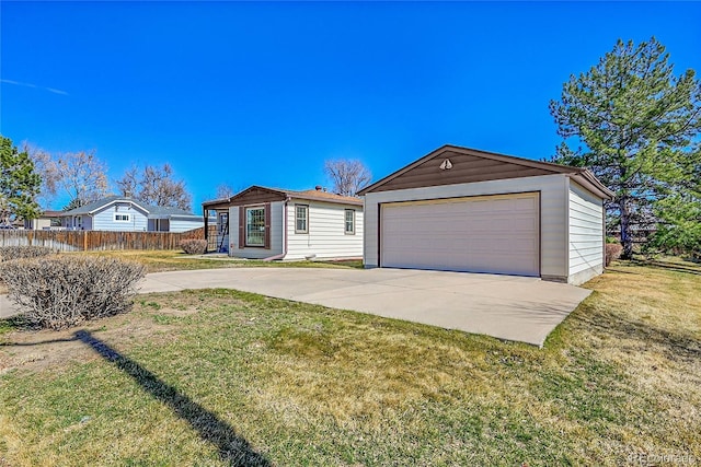 view of front of property with a garage, a front yard, an outdoor structure, and fence