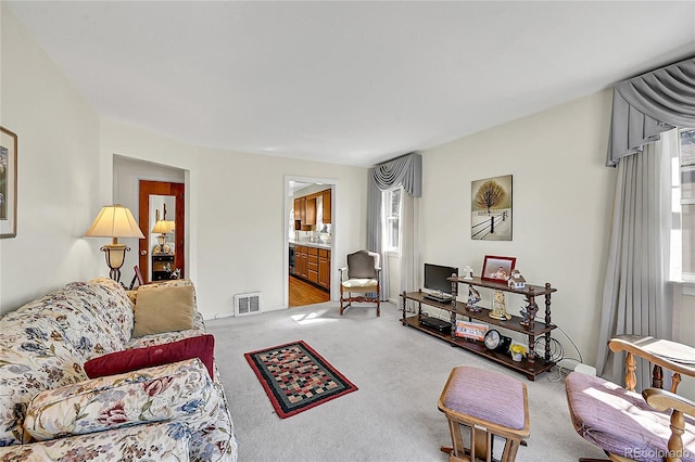 living room featuring visible vents and light colored carpet