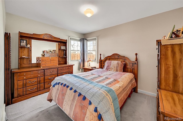 bedroom with light carpet and baseboards